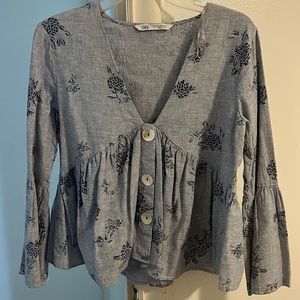 A Zara top in size Medium.